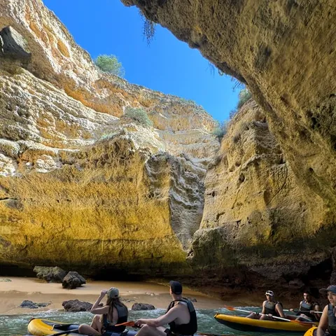 Kayakers below the cliffs at Benagil