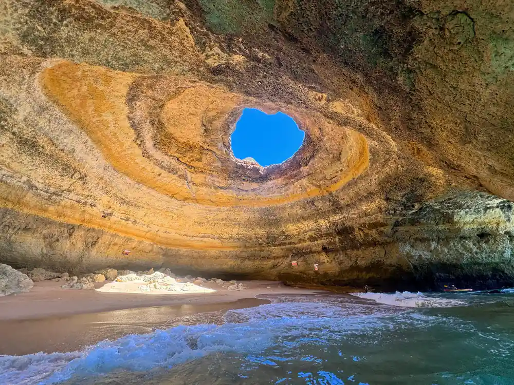 The roof opening seen from the sand with waves running in
