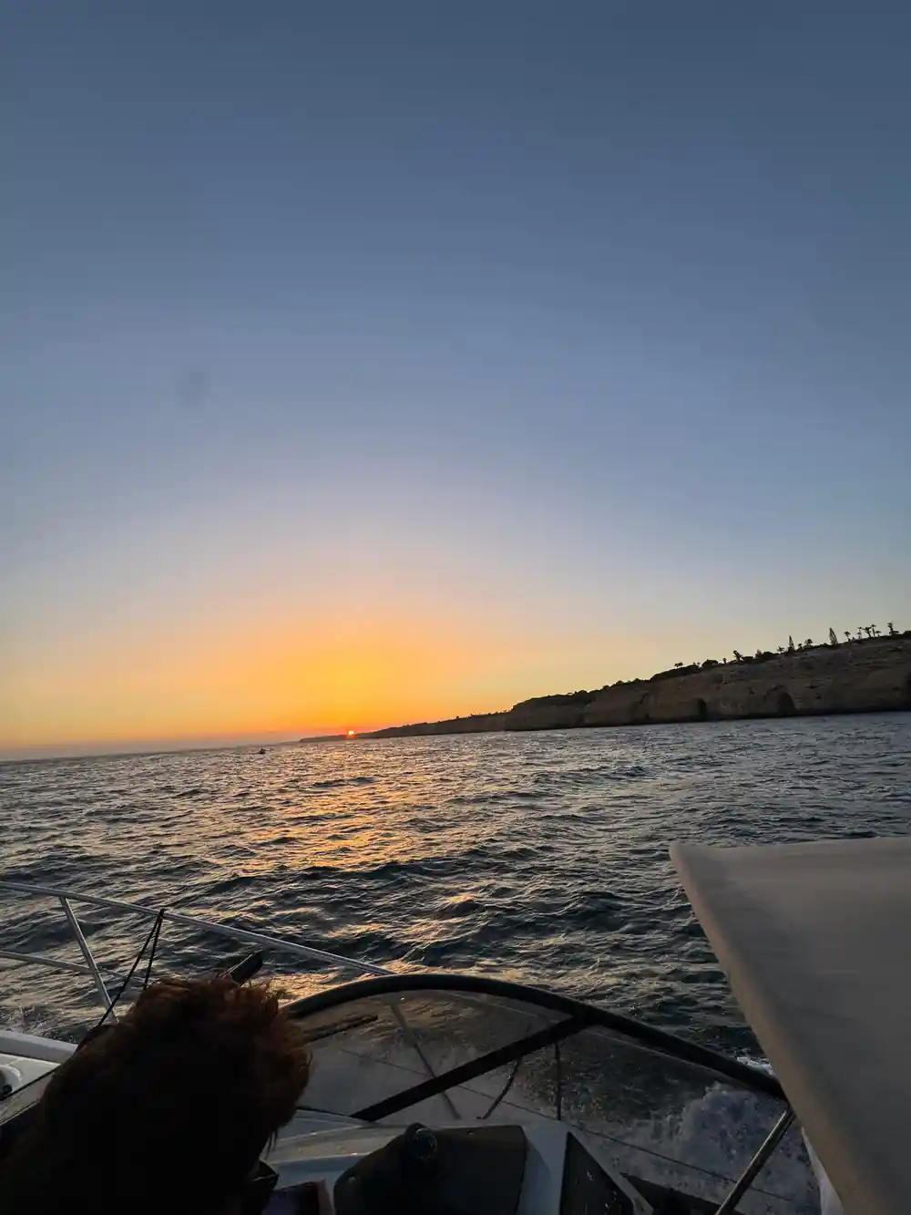 Sunset over the sea seen from the deck of the boat