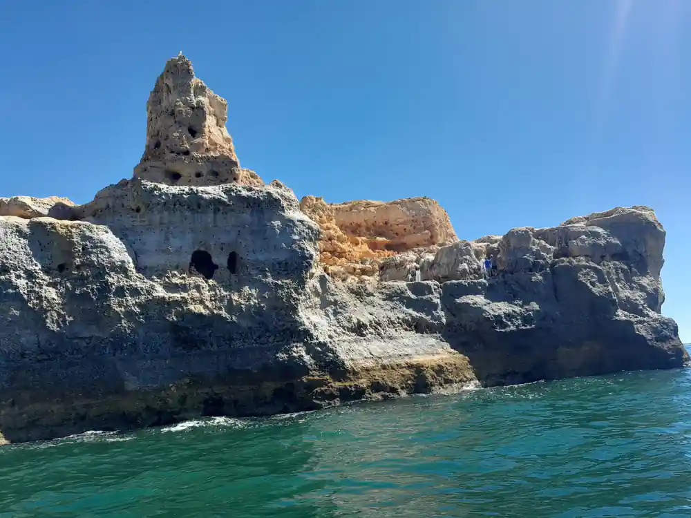 A weathered rock pinnacle standing off the cliff coast